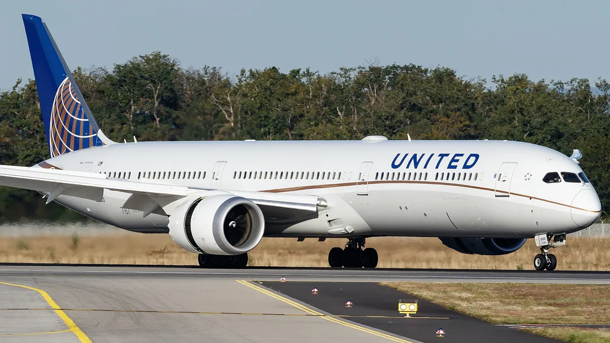 United Airlines Boeing 787-10 N12003 taxiing in side profile, showing its stretched body, raked wingtips, and saw-tooth-edged engine pods.