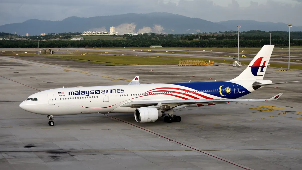 Malaysia Airlines Airbus A330-300 taxiing in side profile, showing its classic upturned wingtip blades and underwing engines.