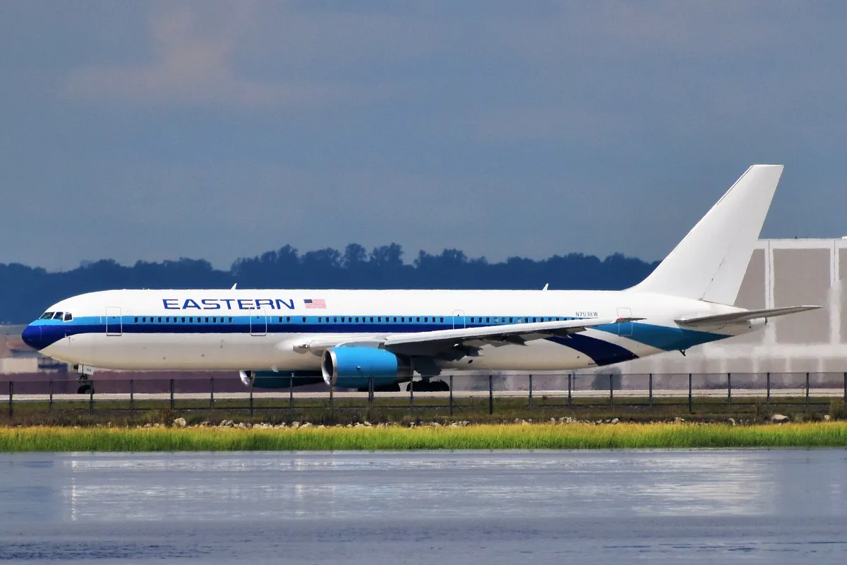 Eastern Airlines Boeing 767-300ER taxiing at JFK Airport, side profile showing its wide twin-aisle body and plain wingtips.