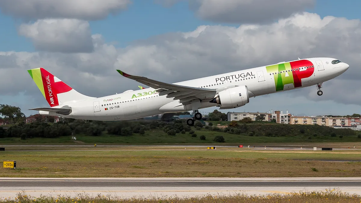 TAP Air Portugal Airbus A330-900neo climbing out on takeoff, three-quarter view showing its large Trent 7000 engine pods and curved wingtip blades.