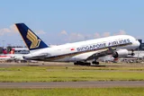 Singapore Airlines Airbus A380-841 climbing away from Sydney Airport in left side profile against a clear blue sky, showing its full double-deck body and four underwing engines.