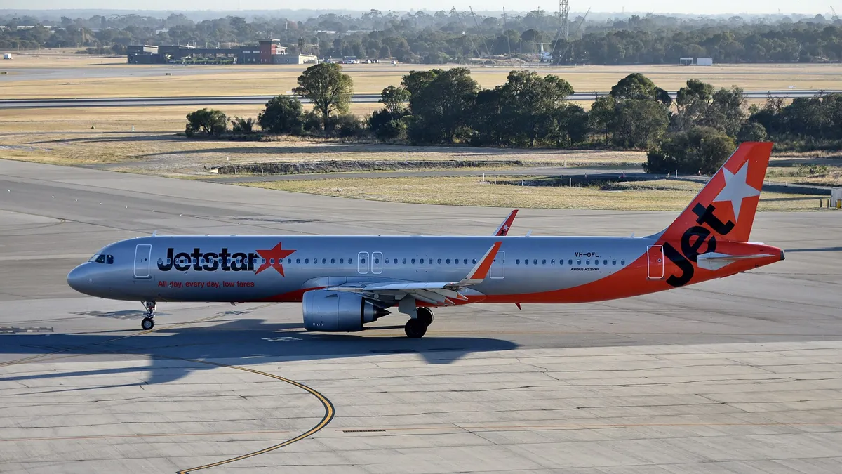 Jetstar Airways Airbus A321-251NX taxiing in side profile, showing the stretched body and the huge LEAP-1A engine pod typical of the neo-generation A321.