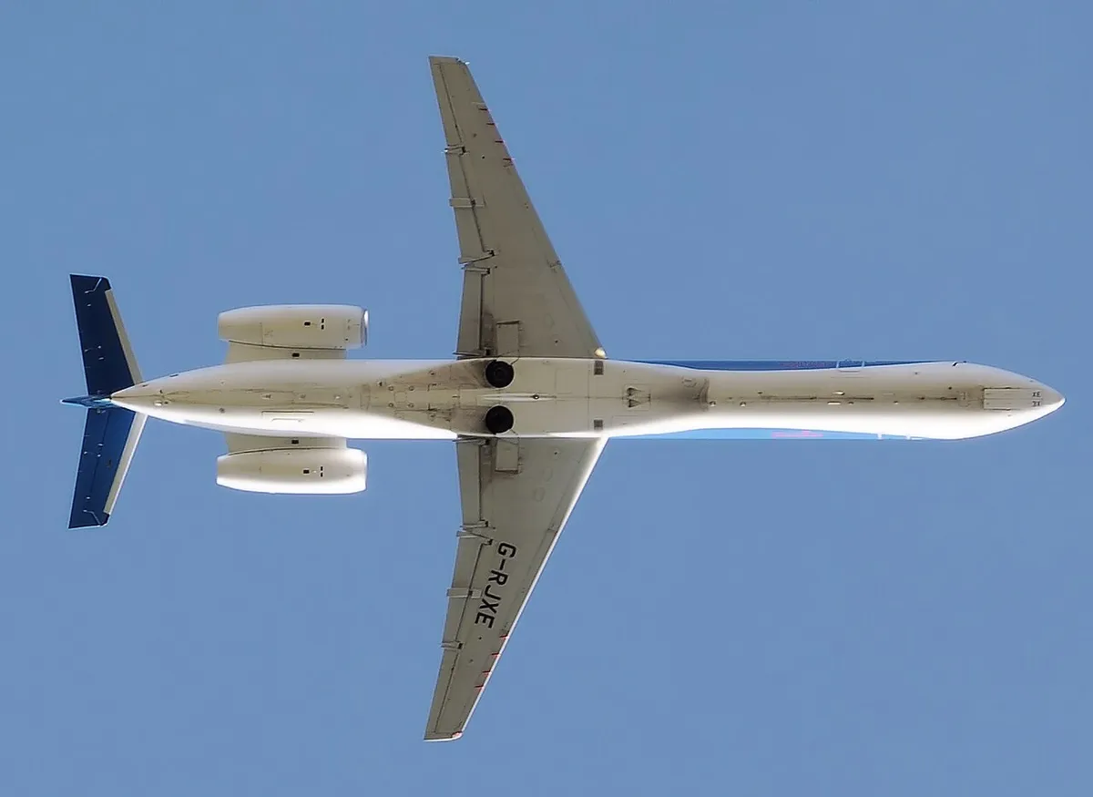 bmi Regional Embraer ERJ145 seen directly from below on takeoff, showing the pencil-thin body, rear-mounted engines, and T-tail.