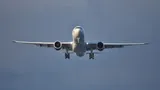Virgin Atlantic Airbus A330-900neo seen head-on from below on final approach, showing the belly, oversized engine pods, and wing shape.