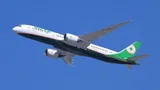 EVA Air Boeing 787-9 B-17889 banking in a climbing turn against a clear blue sky, showing the underside of the wings, engine pods, and body from a below-quarter angle.