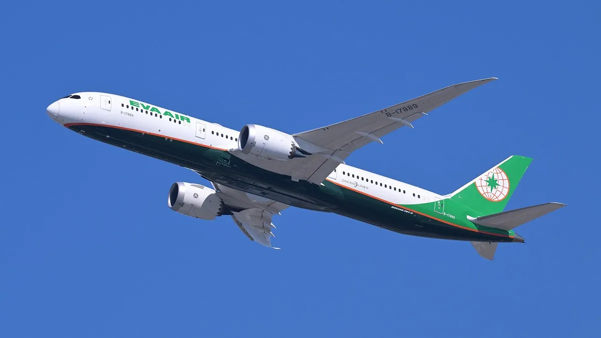 EVA Air Boeing 787-9 B-17889 banking in a climbing turn against a clear blue sky, showing the underside of the wings, engine pods, and body from a below-quarter angle.