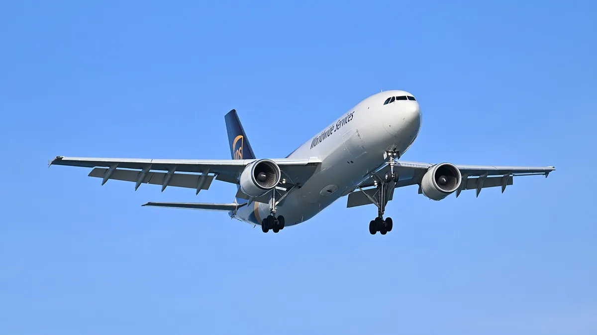 UPS Airbus A300-600F freighter seen from below-quarter on final approach, showing the belly, underwing engines, and extended landing gear.
